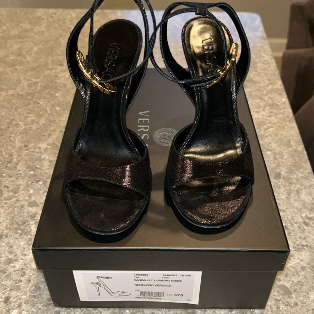 Versace black micro-suede leather heels with gold safety pin buckle.